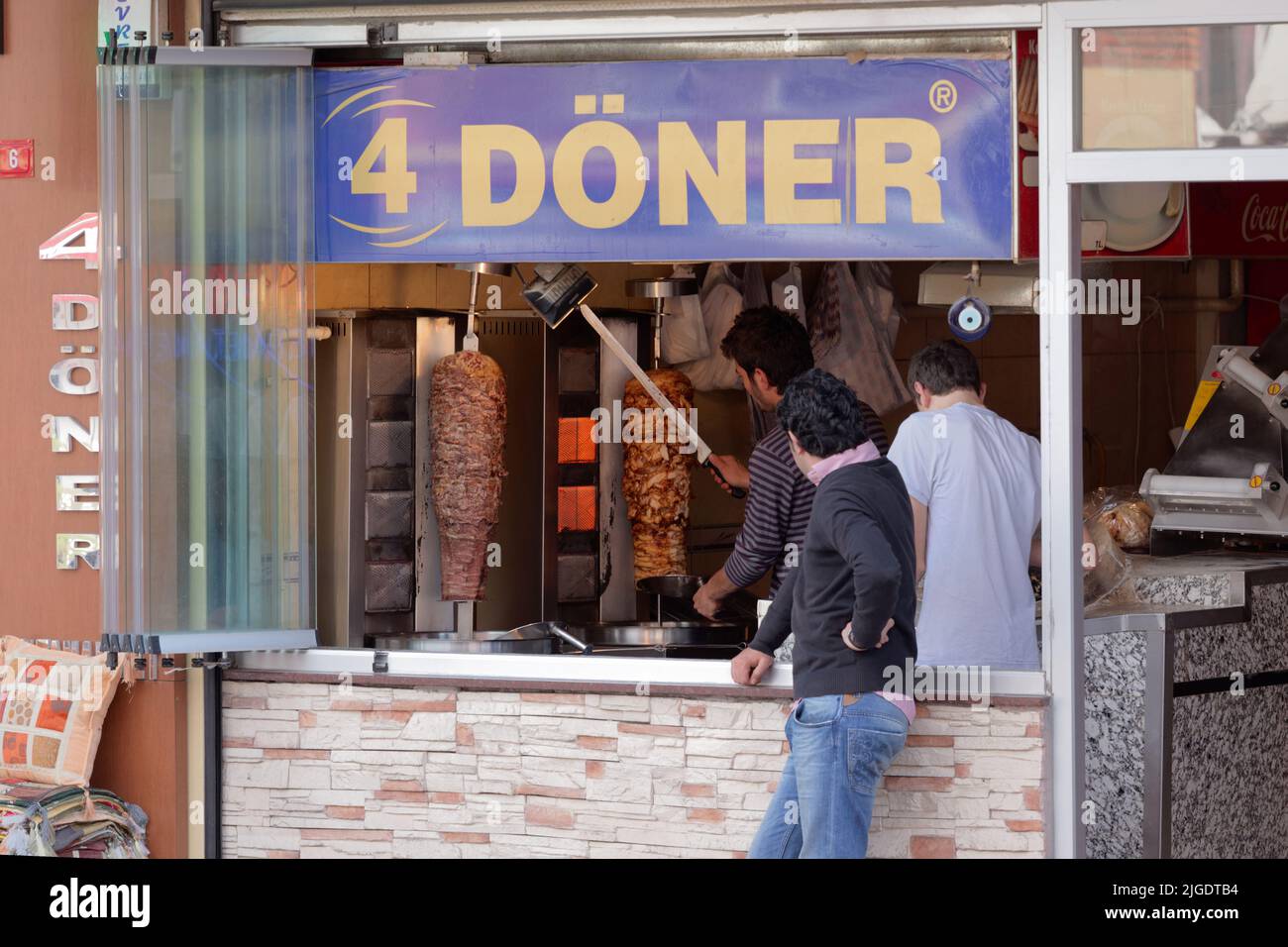 Men cooking the doner kebabs in a street cafe in Istanbul, Turkey Stock Photo