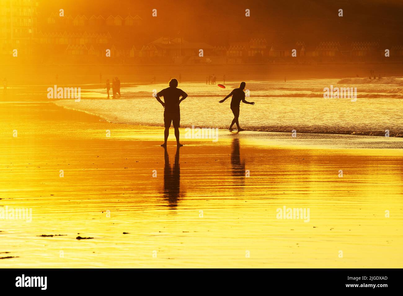 Scarborough, North Yorkshire, UK. 9th Jul 2022. People play frisbee in the late evening sun on North Bay beach at Scarborough, North Yorkshire. Neil Squires/Alamy Live News Stock Photo