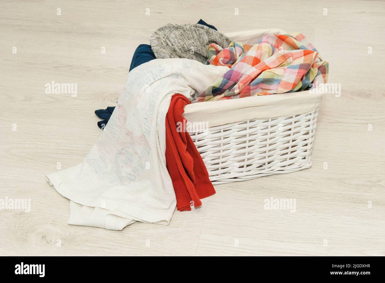 dirty linen for washing in a wicker basket Stock Photo Alamy