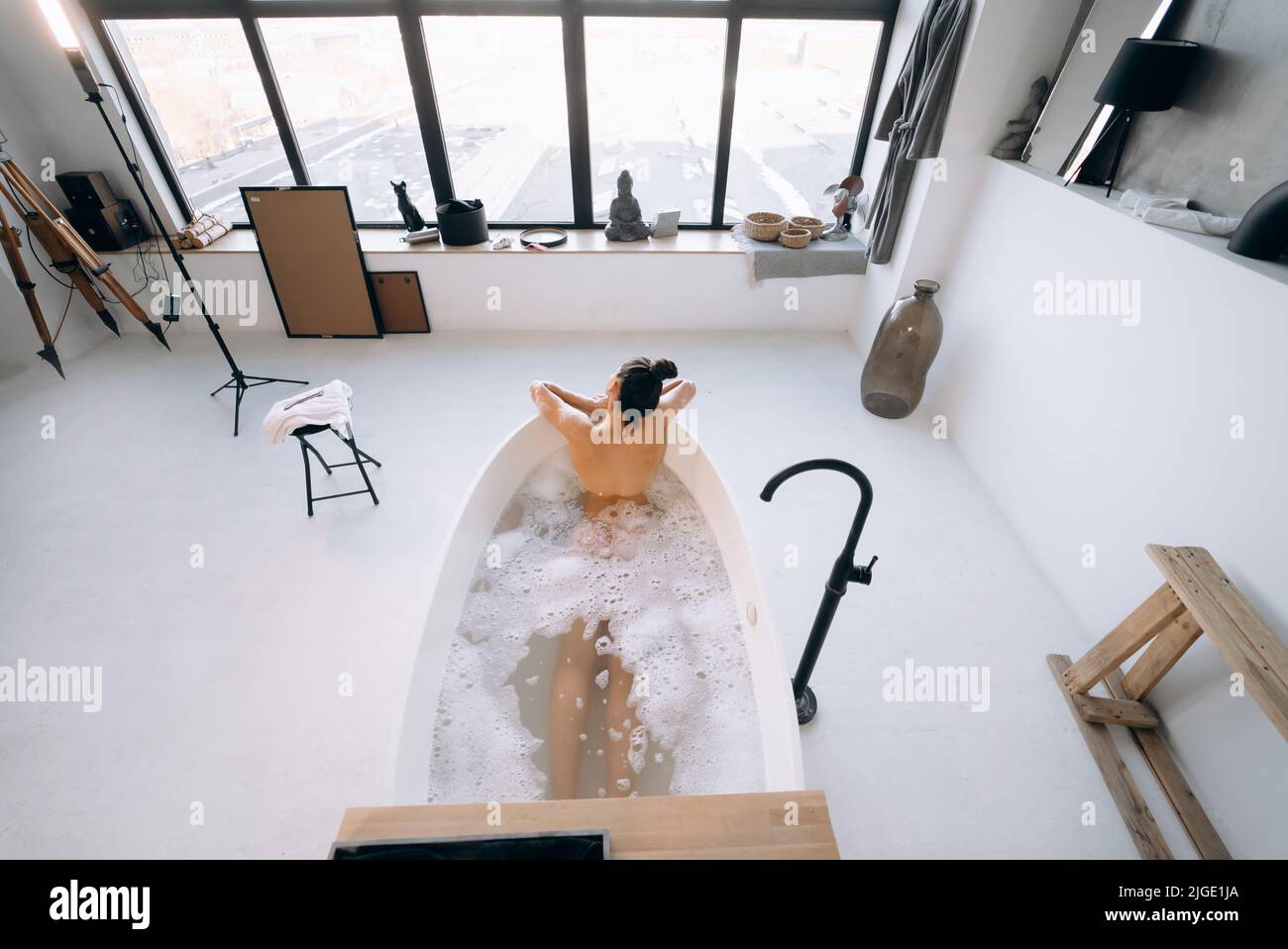 Relaxed lady taking bath, enjoying and relaxing while lying in bathtub