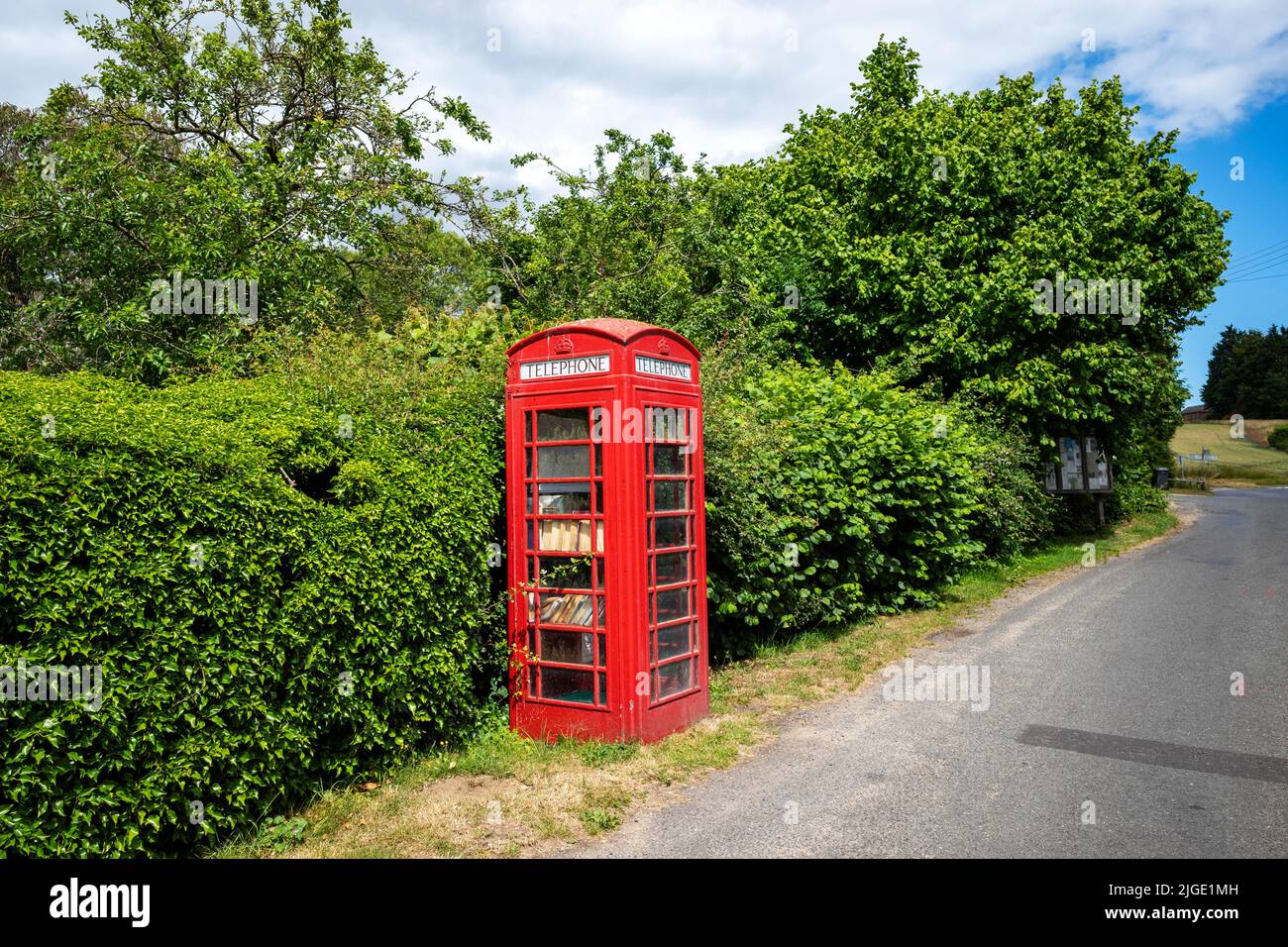 Former BT red telephone box now used as a library Parham Suffolk UK Stock Photo