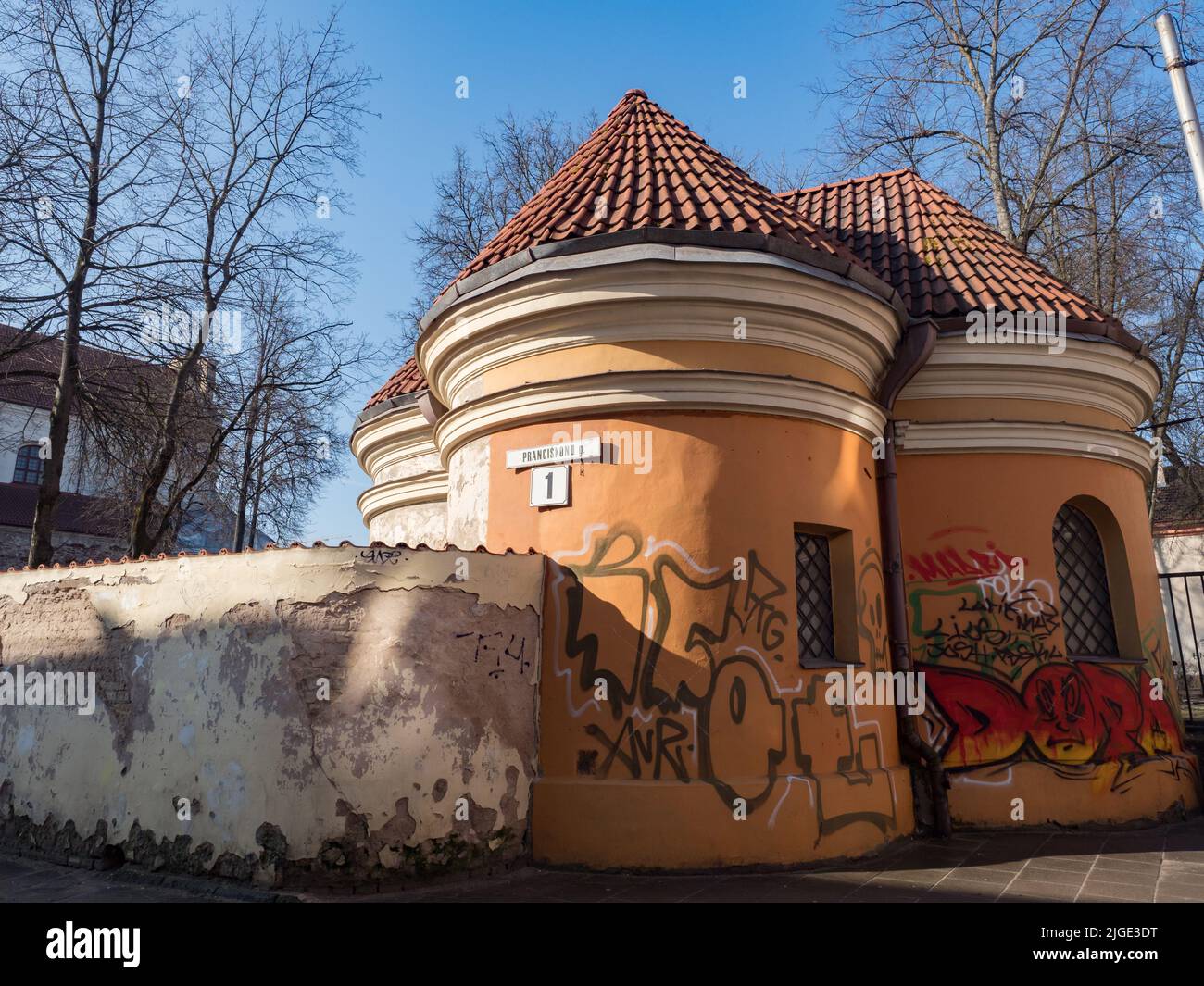 Vilnius, Lithuania - April 2018: Chapel in the fence by the Church of the Assumption of the Virgin Mary and the Franciscan abbey. East Europe. Prancis Stock Photo
