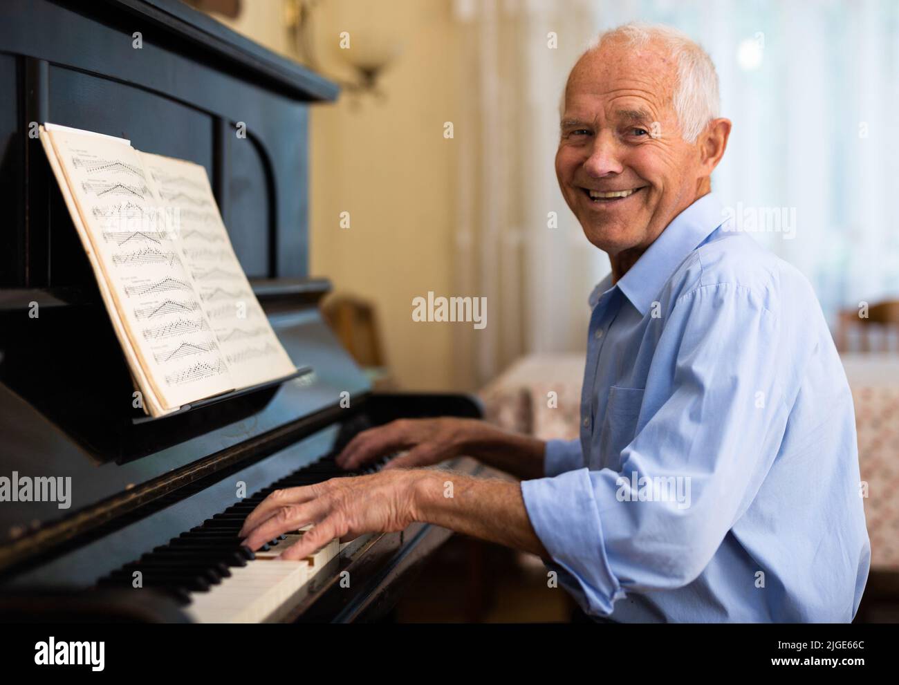 Senior man learning to play piano Stock Photo - Alamy