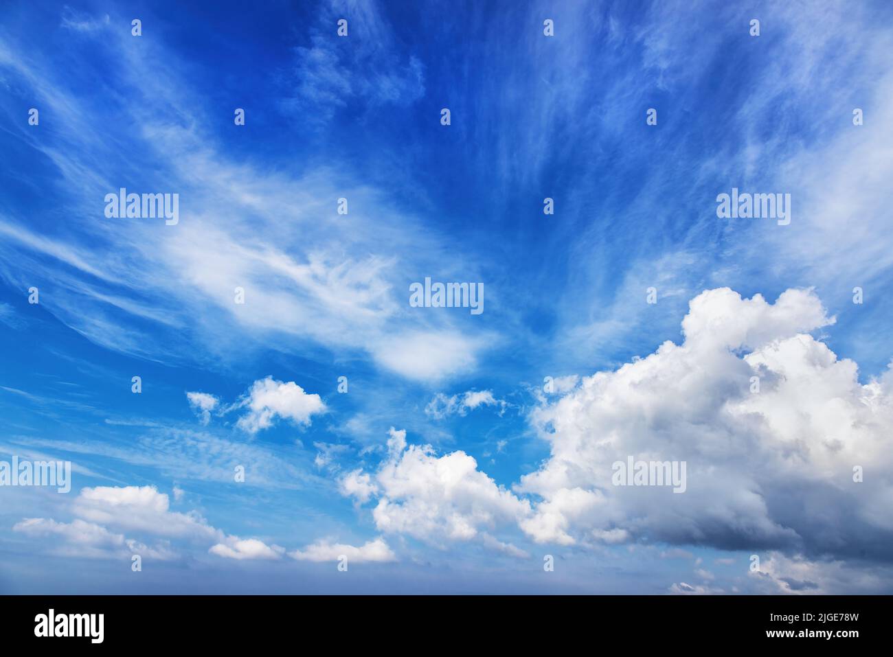 Summer blue sky and white clouds background. Tranquil backdrop, ideal for compositing. Stock Photo