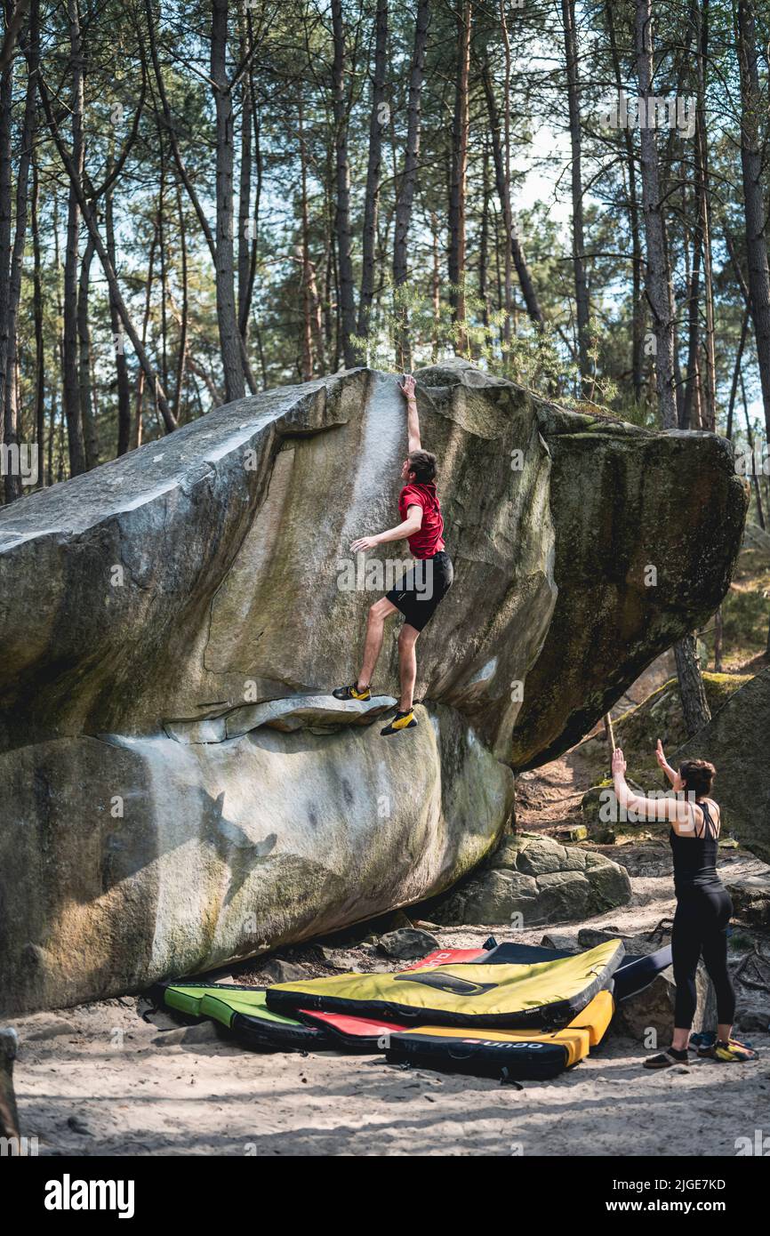 Jumping Hard Athletic young man is jumping for top hold in famous and hard dyno ...