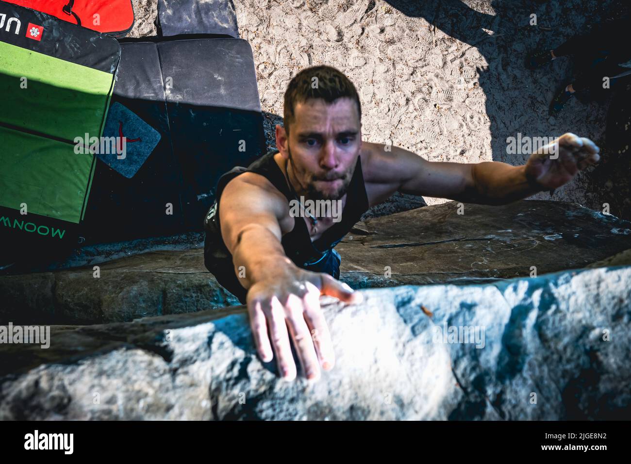 Climber jumps to top hold of dynamic jump boulder Stock Photo Alamy