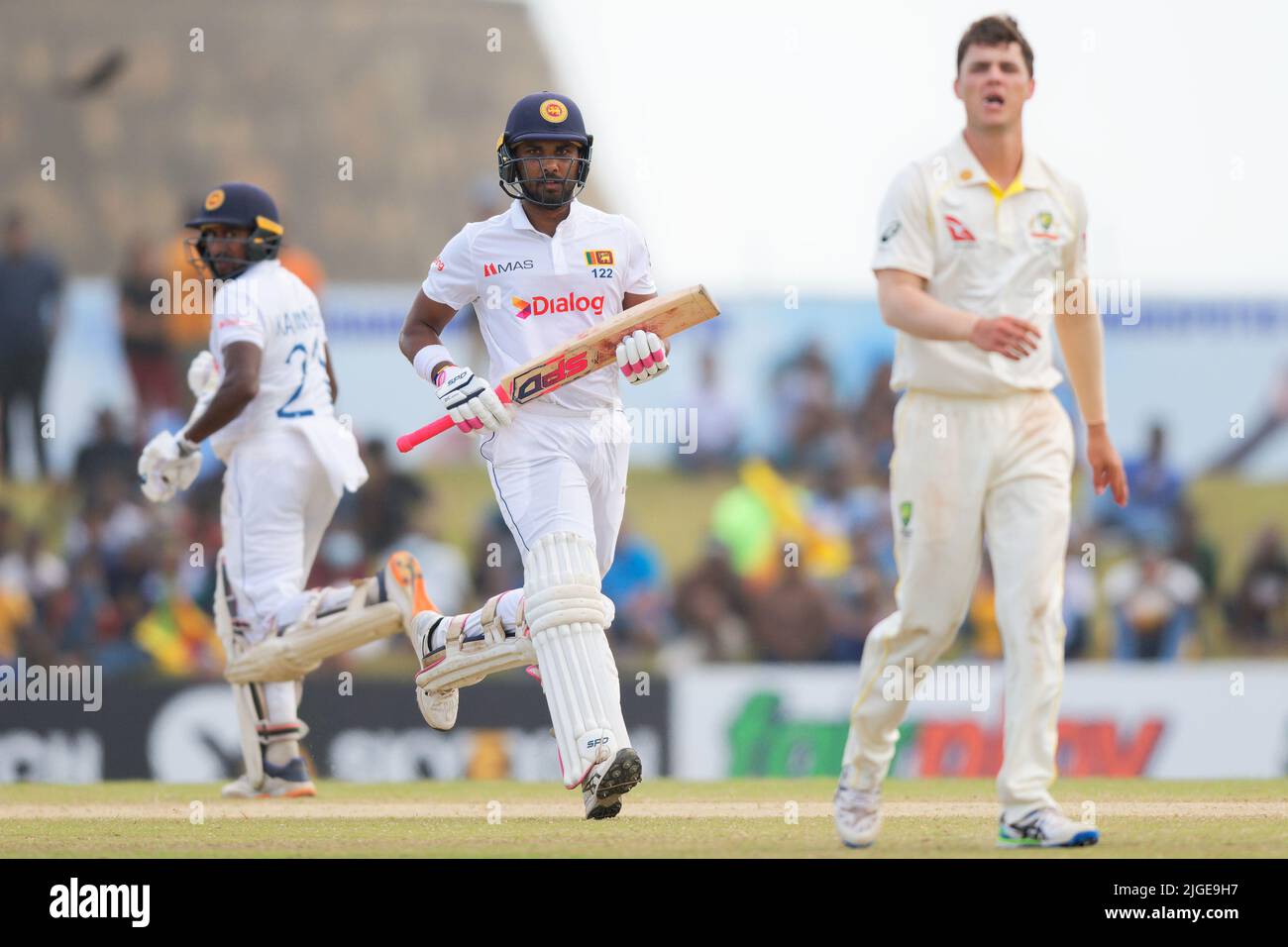 Galle, Sri Lanka. 10th July 2022. Australia's Mitchell Swepson (R) watches the ball as Sri Lanka's Dinesh Chandimal (C) and Kamindu Mendis (L) run between the wickets during the 3rd day of the 2nd test cricket match between Sri Lanka vs Australia at the Galle International Cricket Stadium in Galle on 10th July, 2022. Viraj Kothalwala/Alamy Live News Stock Photo