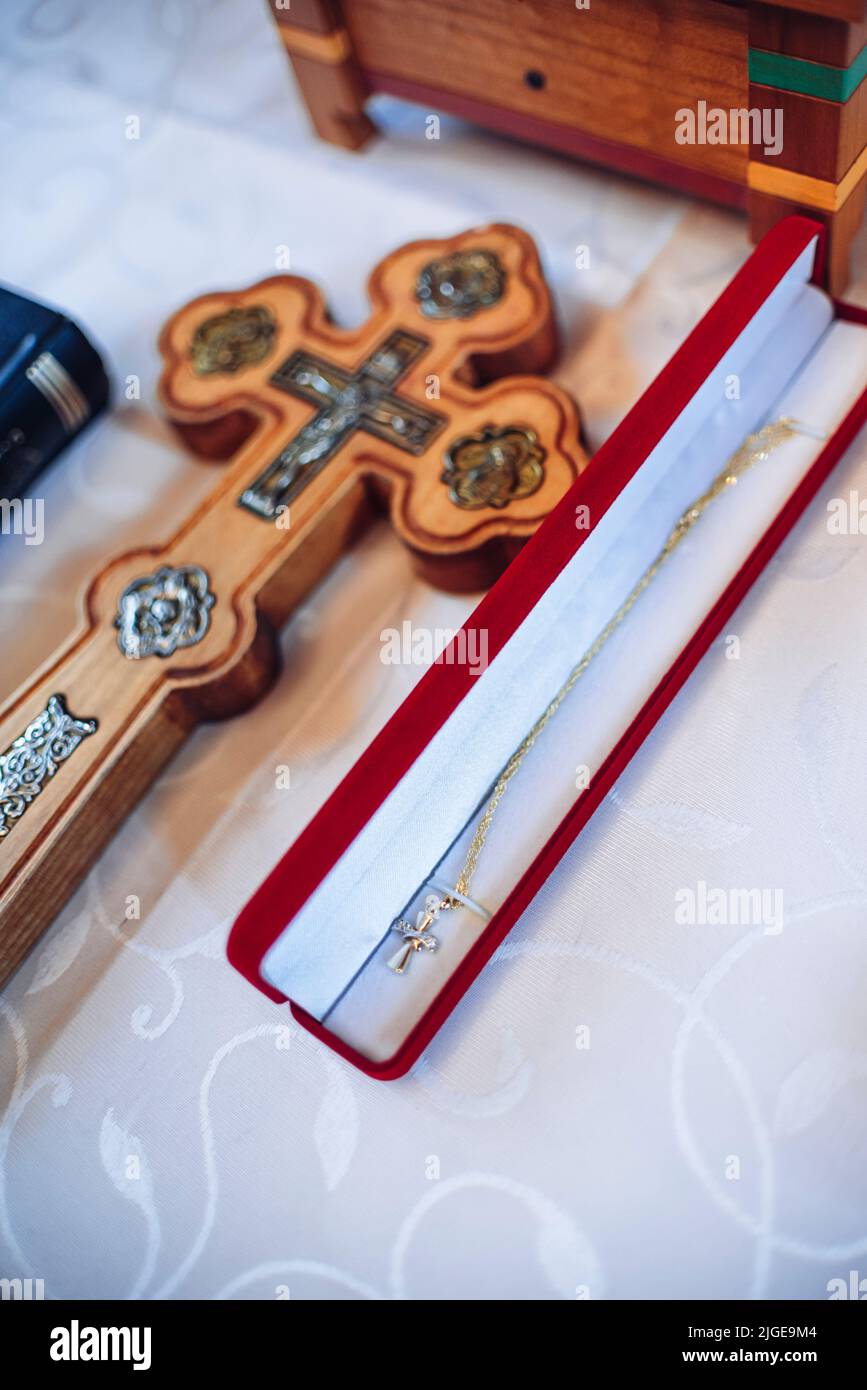 A little golden cross in a jewelry box prepared for a baby's