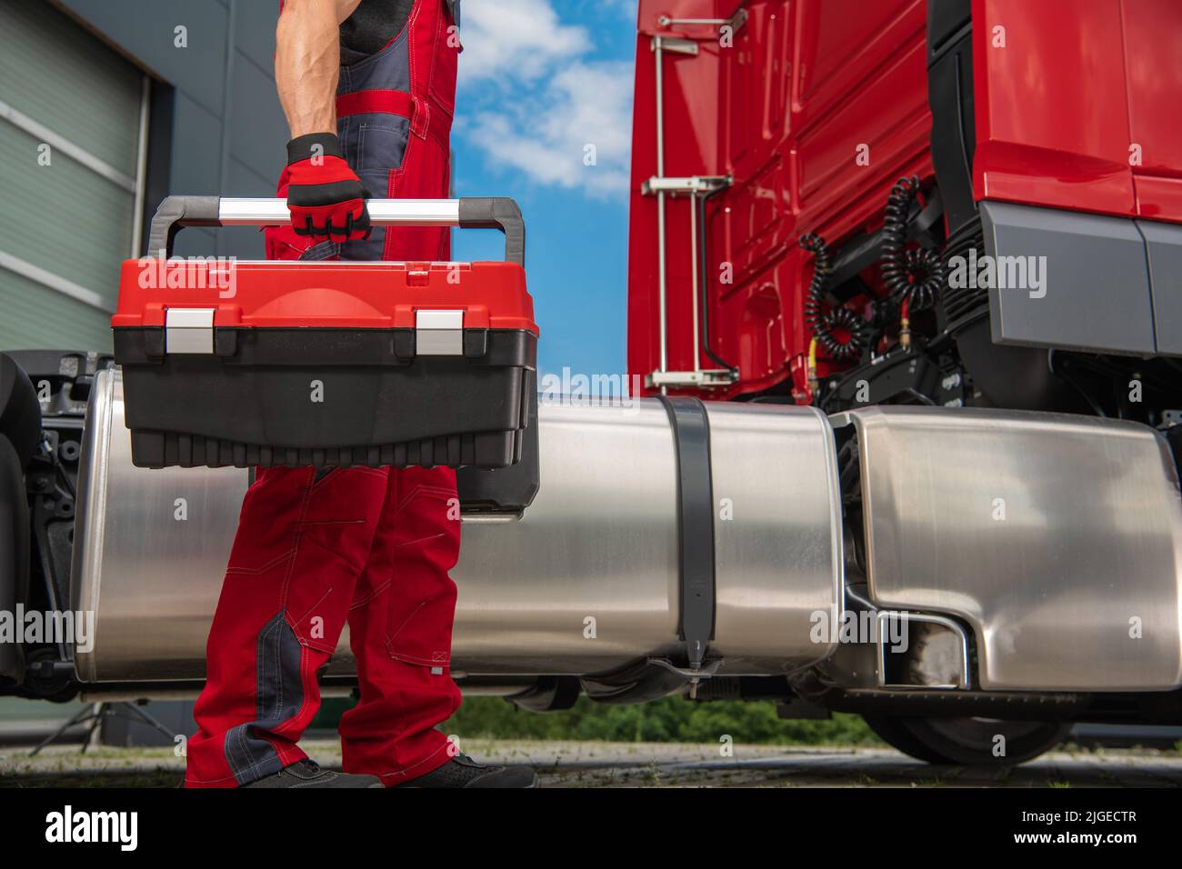 Semi Trucks Professional Mechanic with His Tools Box in Hand Walking