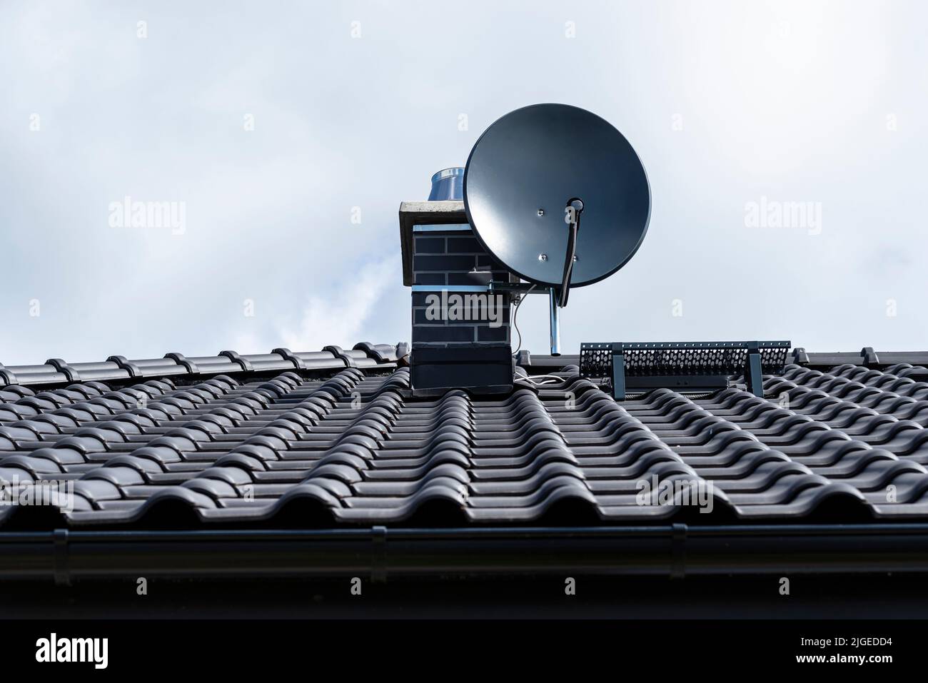 Graphite satellite dish mounted to the chimney with the chimney holder Stock Photo Alamy