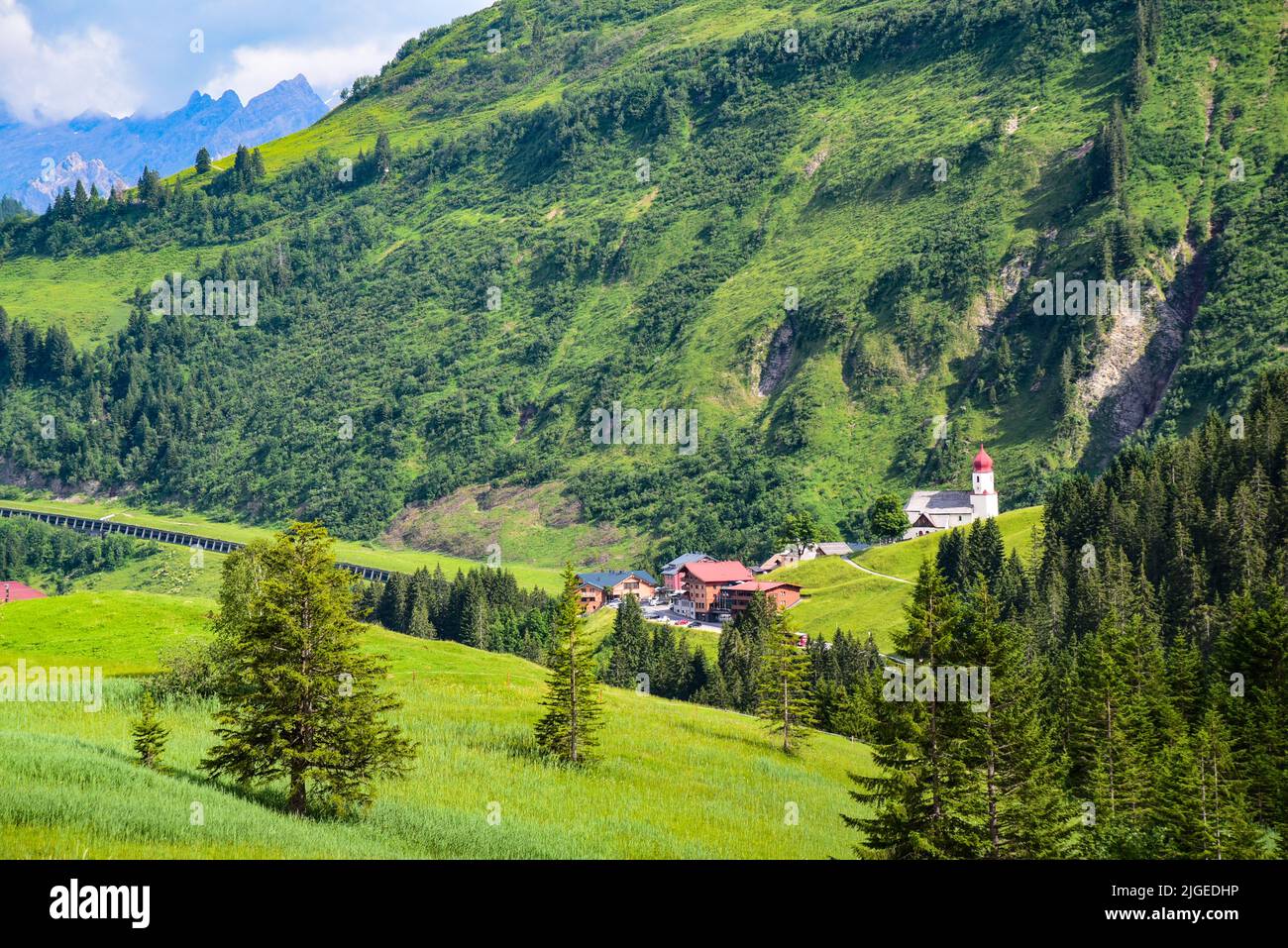 View of Damüls and the village church of Sankt Nikolaus in the Bregenz Forest in the background the Rote Wand (2704 m) in the Lechquell Mountains, Vor Stock Photo