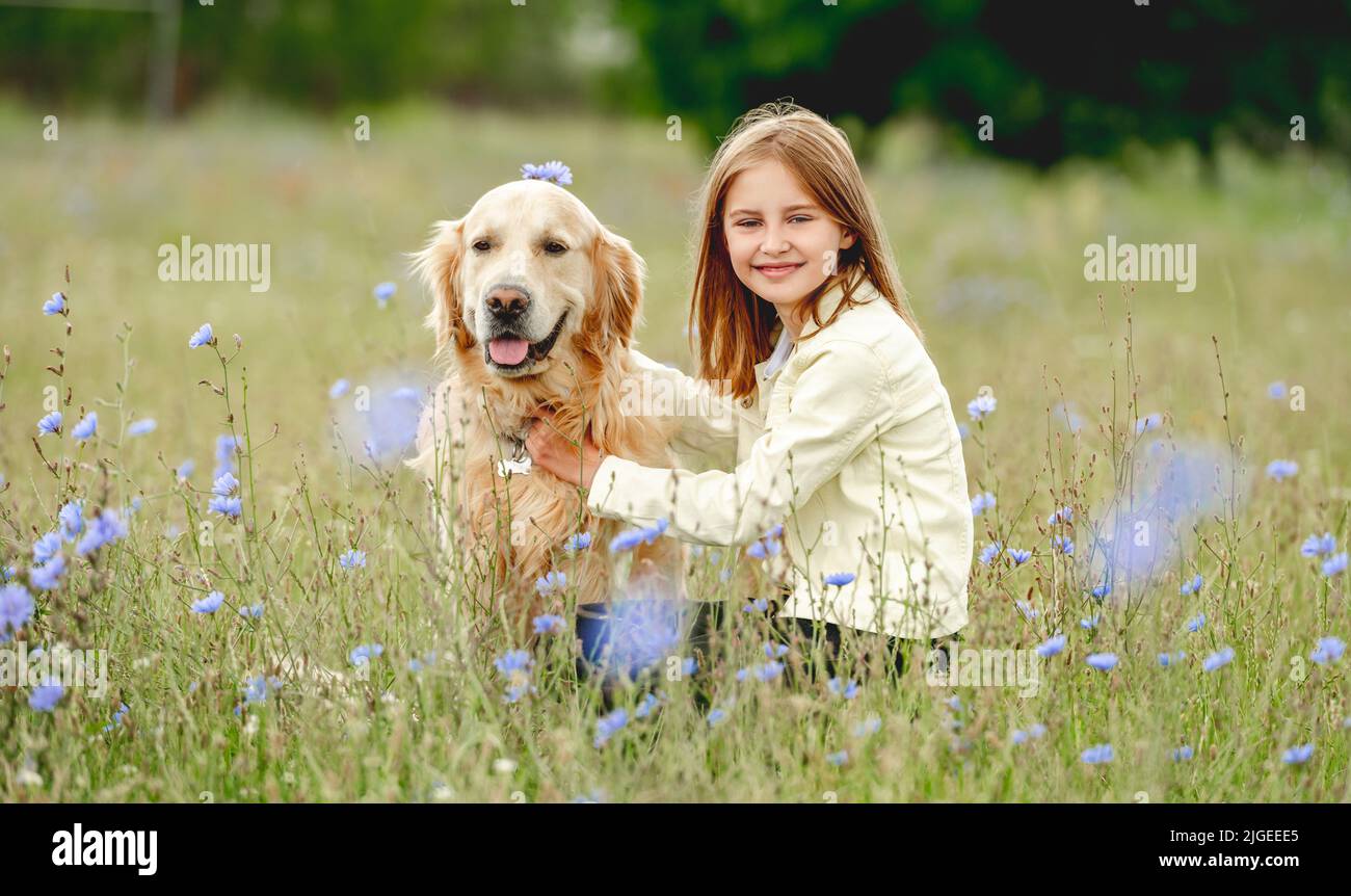 Preteen girl with golden retriever outdoors Stock Photo - Alamy