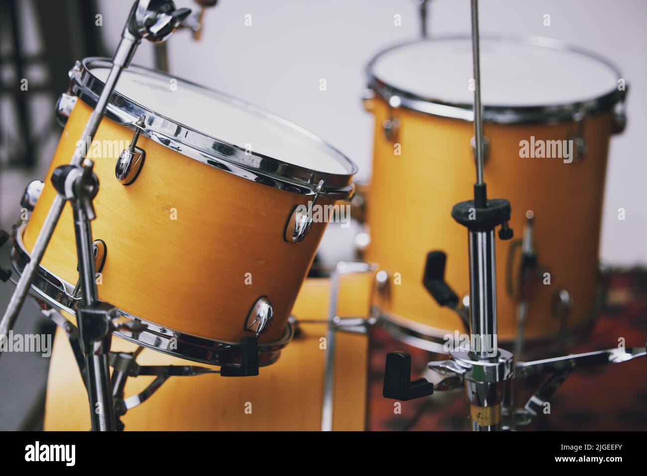 Time to get creative. a drum set in an empty studio during the day. Stock Photo