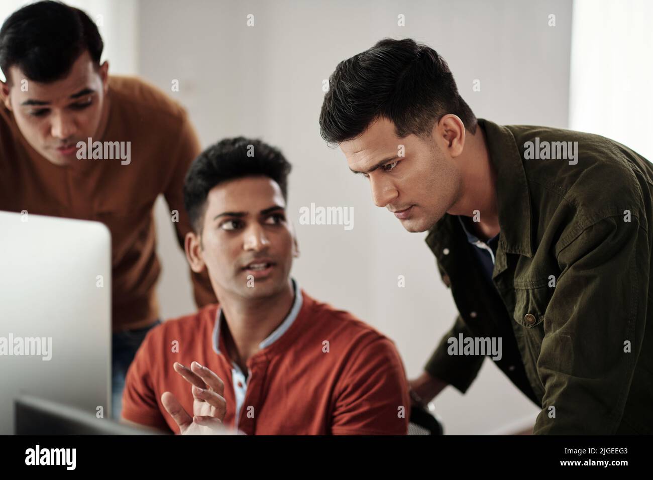 Software developers asking team lead to help with crashed website Stock Photo