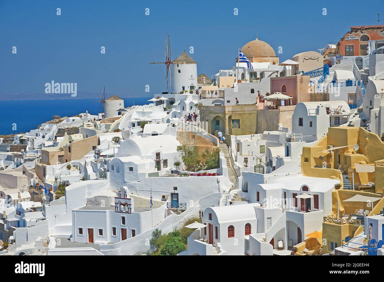 Oia, or Ia a picturesque village of white washed houses and traditional windmill on the island of Santorini, part of the Greek Cyclades Islands Stock Photo