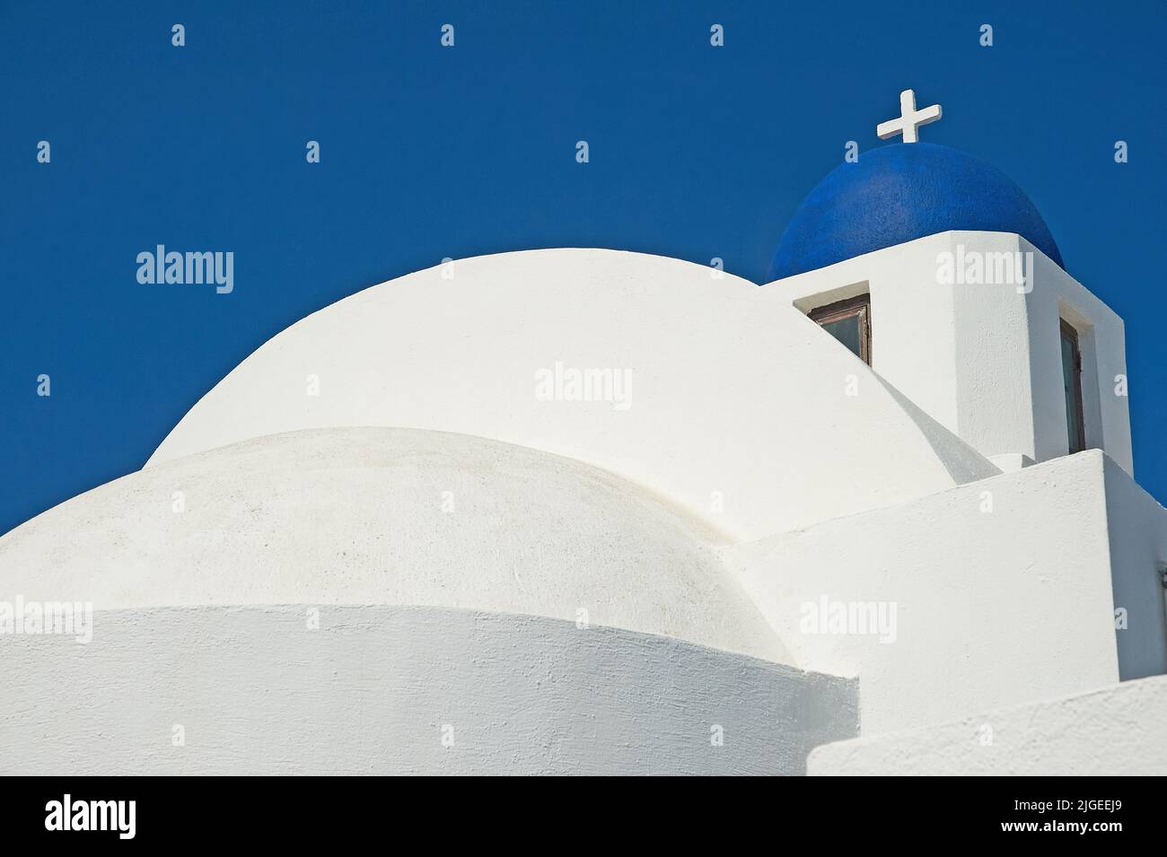 Typical white walled and blue domed church on the island of Santorini, Greece Stock Photo