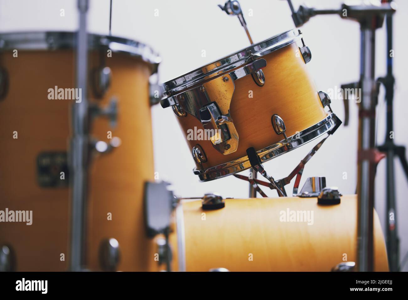Life would be dull without music. a drum set in an empty studio during the day. Stock Photo