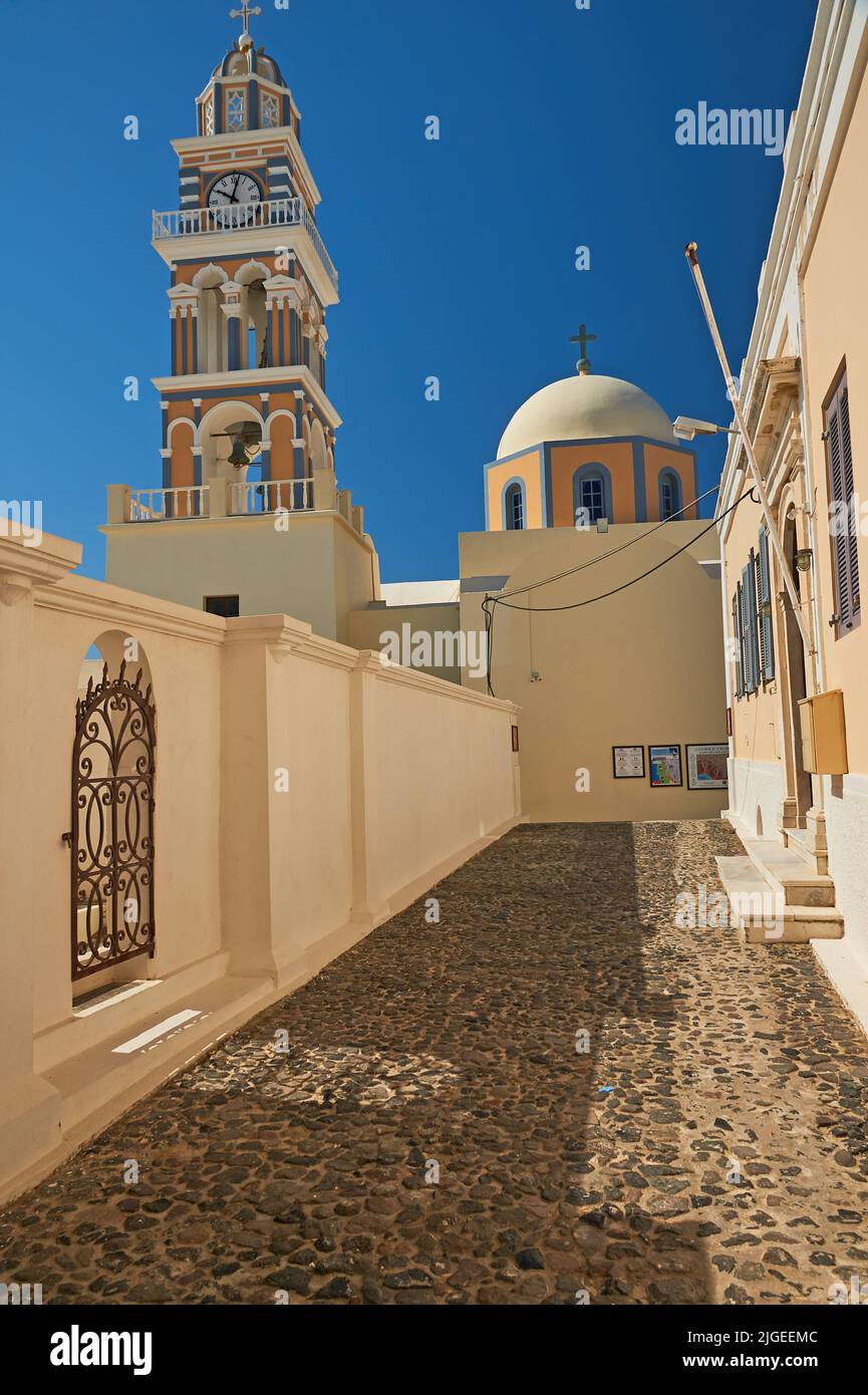 Dome and ornate clock tower of St John the Baptist cathedral in Thira (Fira) on the island of Santorini, Greece Stock Photo