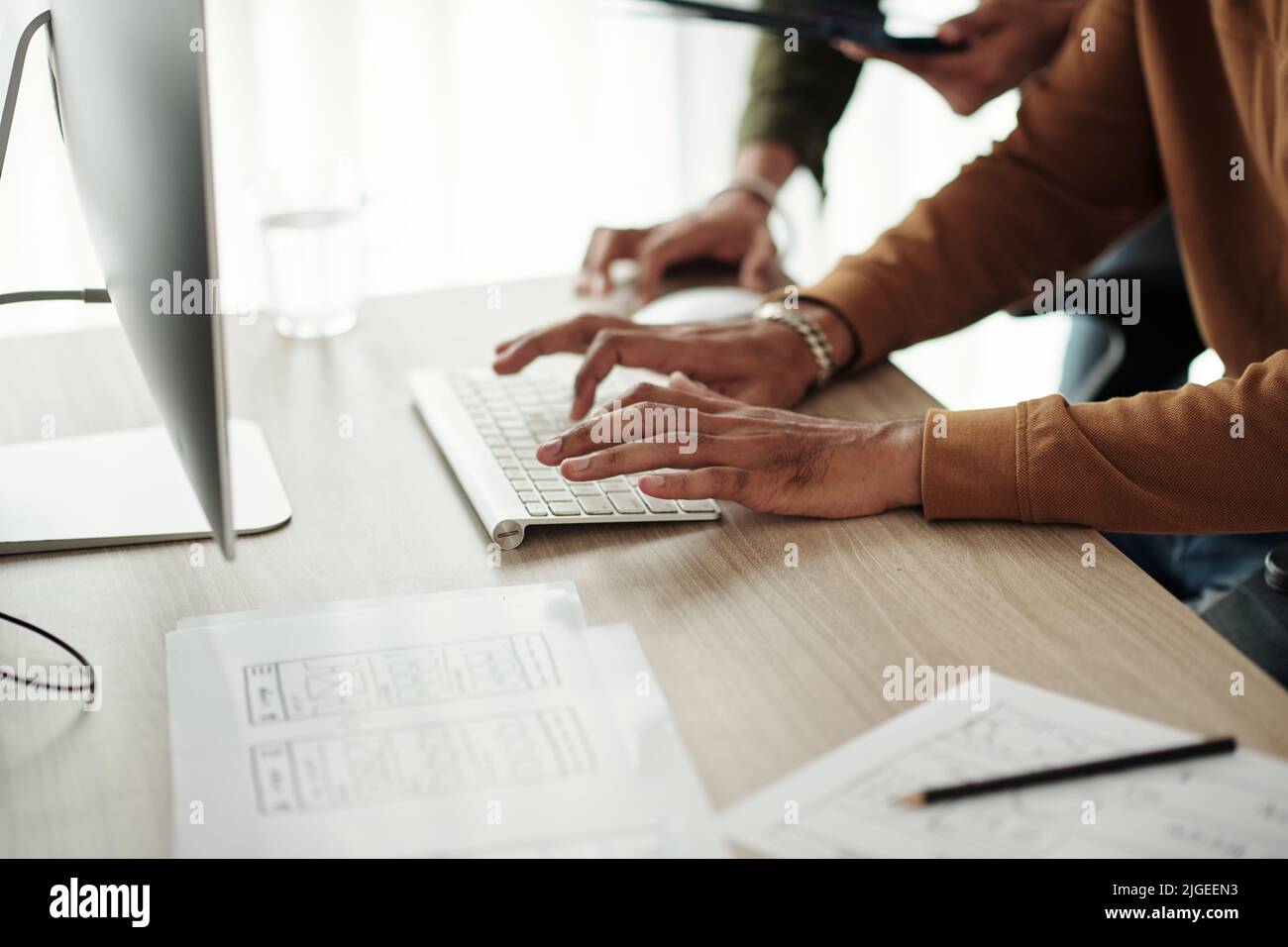 Hands of developer writing and debugging code on computer in office Stock Photo