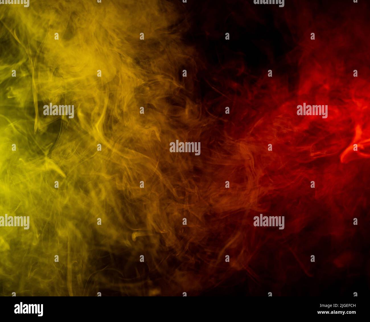 Red-yellow smoke spreads on a black background Stock Photo - Alamy