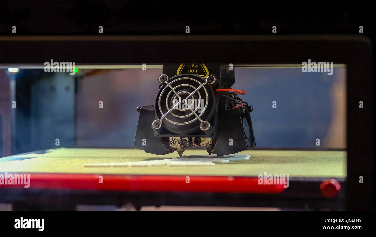 Close-up 3d printer laser creating a white model. Modrn hi-tech technology. Stock Photo