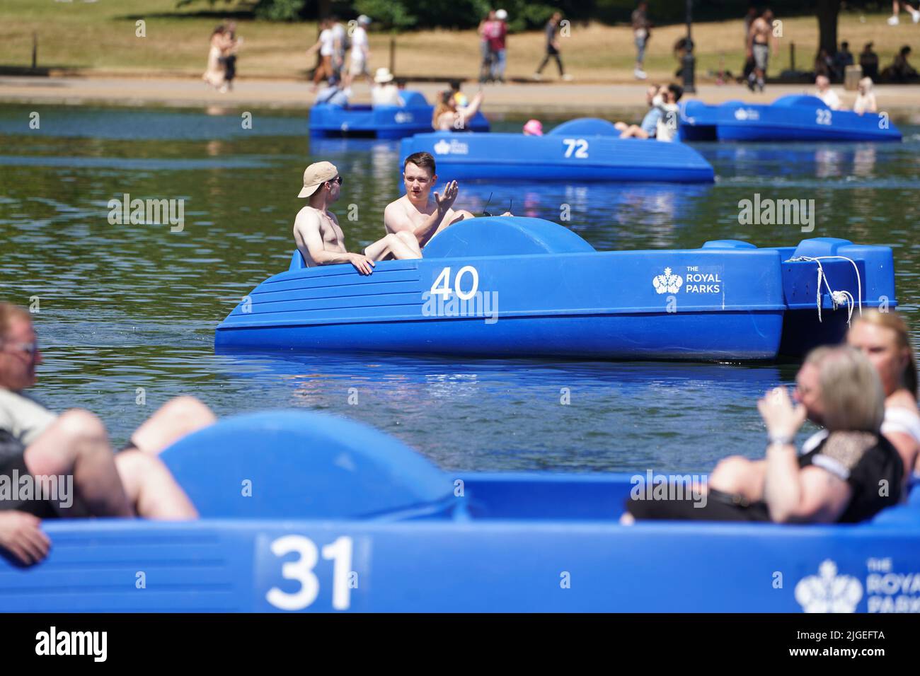 People in pedalos on the Serpentine, Hyde Park, London. Picture date