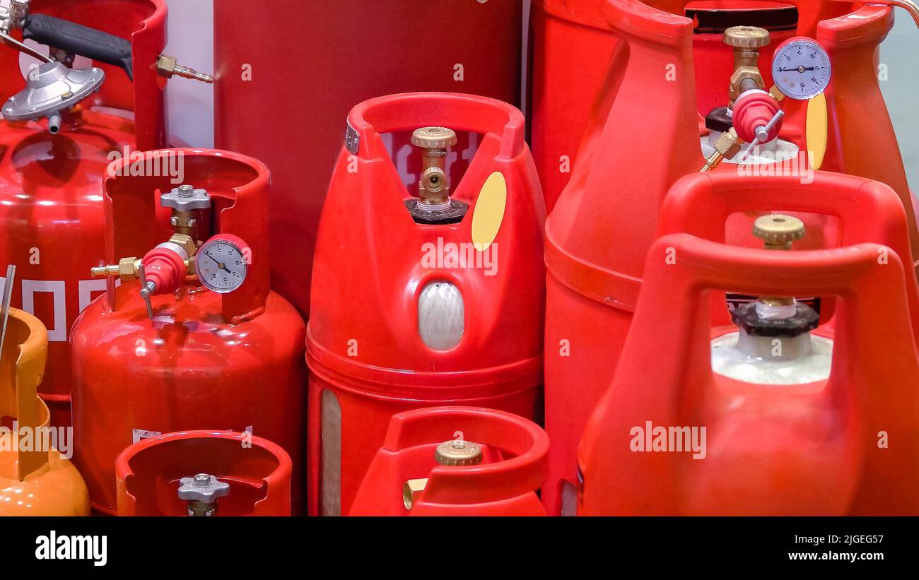 Storage of many various gas cylinders with propane. Red blue and orange