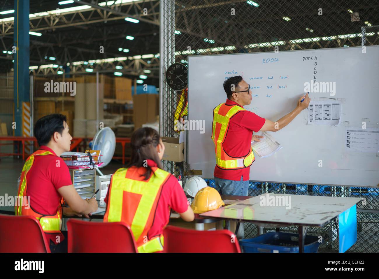 The team leader is the dispatcher. technician training Supervisors, engineers, in the morning meeting before work where everyone wears masks to preven Stock Photo