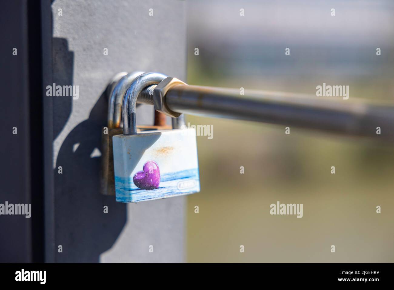 A padlock with a heart-design locked on a metal railings Stock Photo ...