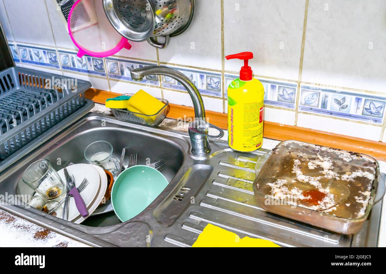 Dirty dishes unwashed in the sink Stock Photo