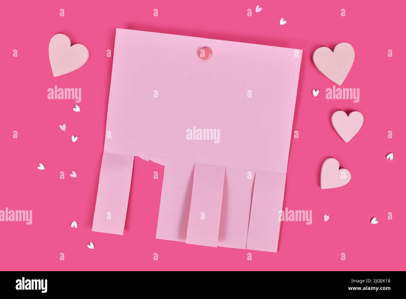 Pink empty tear-off stub paper note without text with heart ornaments Stock Photo