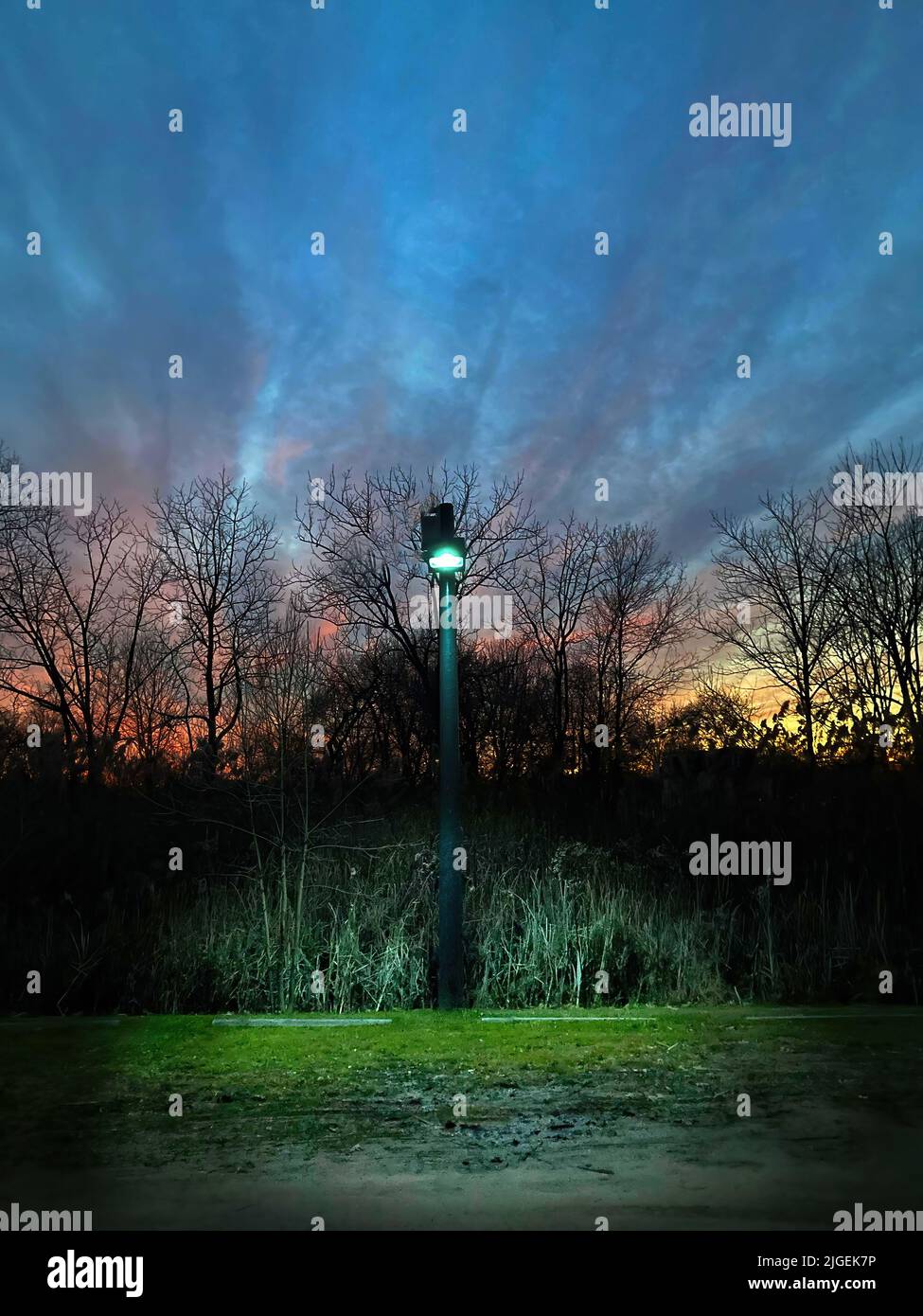 Solitary light post at sunset Stock Photo