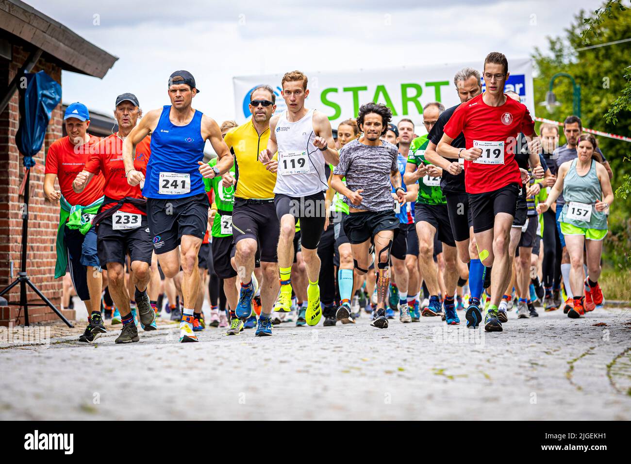 Bruchhausen Vilsen, Germany. 10th July, 2022. Runners start in the 'Man against Machine' race in the Diepholz district. The running course runs mainly parallel to a running steam train of the museum railroad. Credit: Moritz Frankenberg/dpa/Alamy Live News Stock Photo