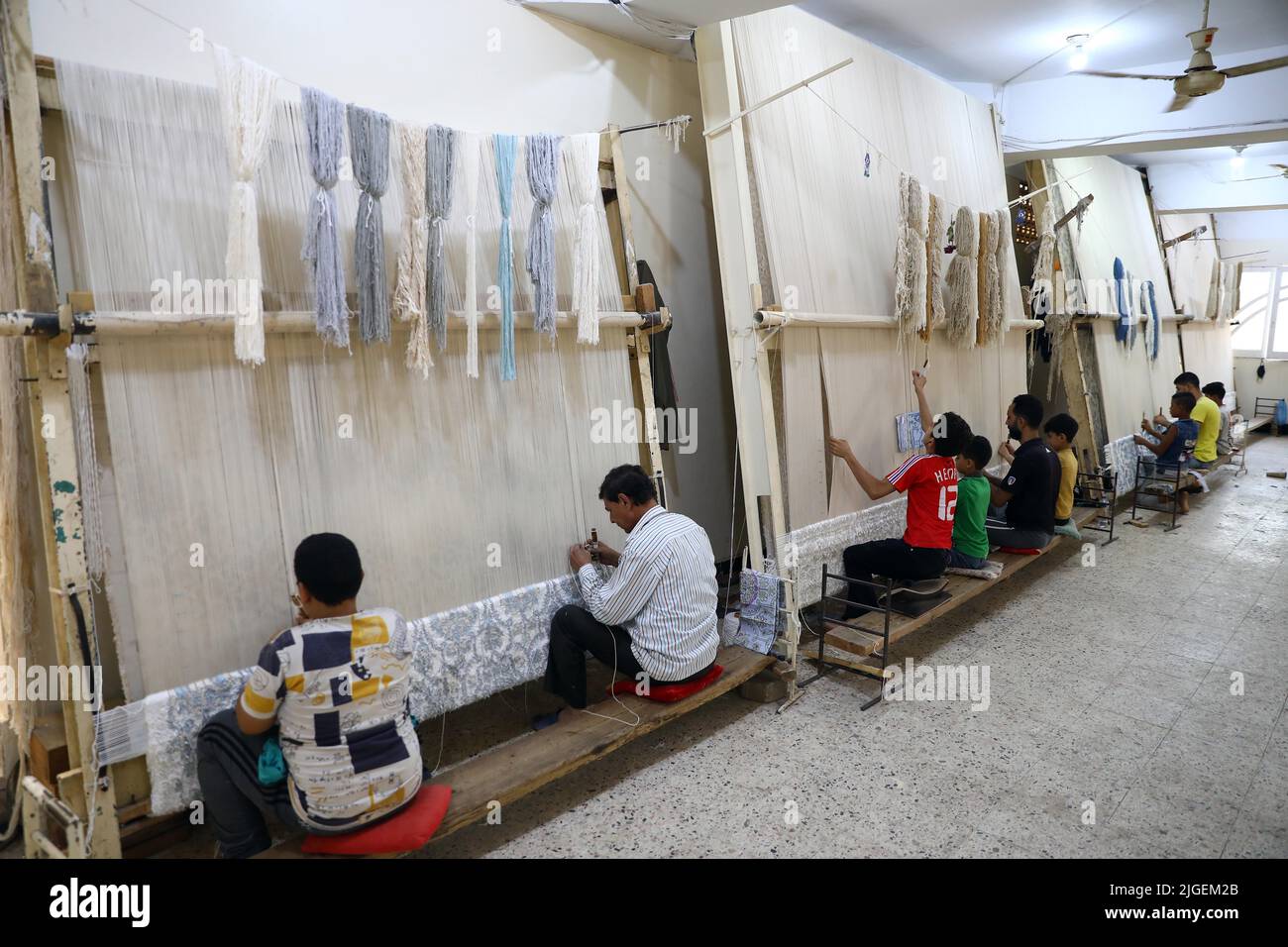 Giza, Egypt. 2nd July, 2022. People weave carpets at a weaving