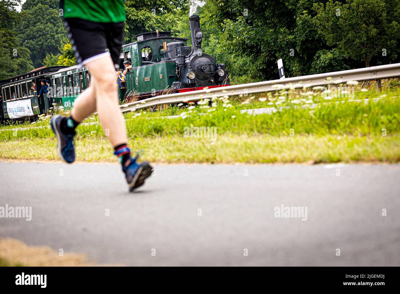Bruchhausen Vilsen, Germany. 10th July, 2022. A runner takes part in the 'Man against Machine' race in the Diepholz district. The running course runs mainly parallel to a running steam train of the museum railroad. Credit: Moritz Frankenberg/dpa/Alamy Live News Stock Photo