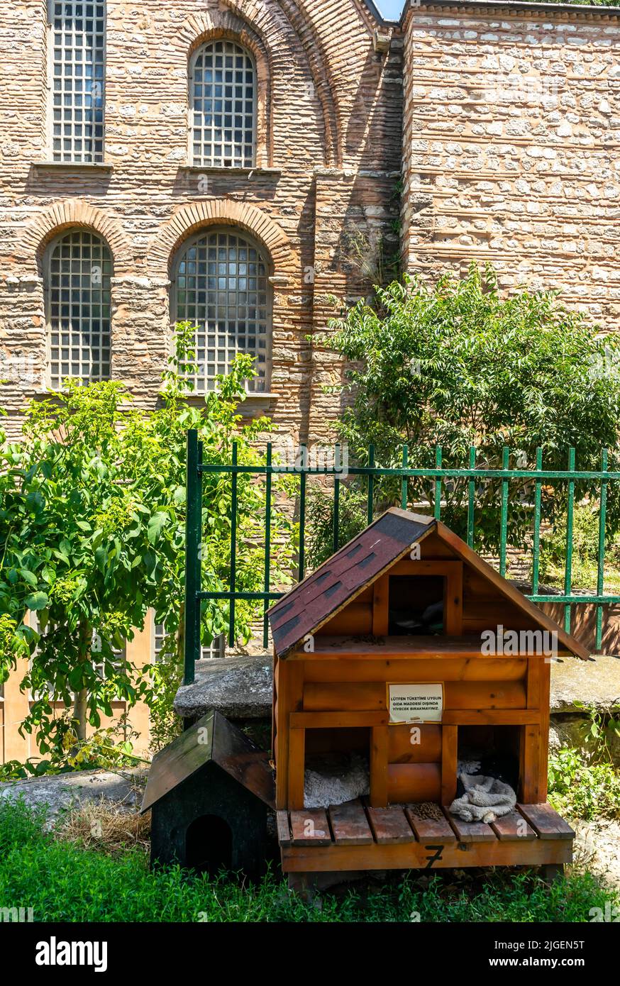 Pets wooden house in Fatih, Istanbul. House for animals installed near historic church with note about feeding pets. Turkey Stock Photo