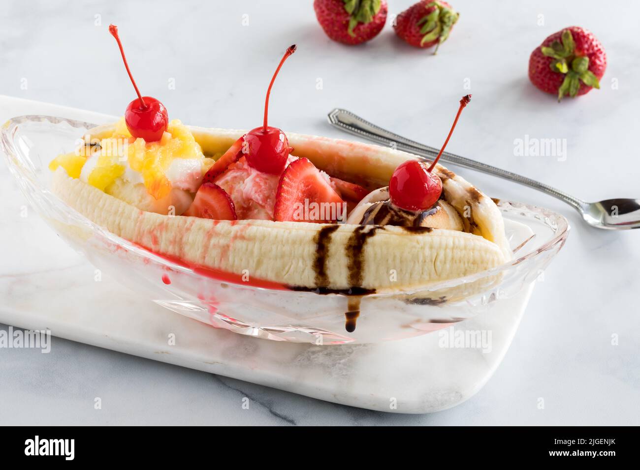 Delicious banana split with chocolate sauce dripping down the side. Stock Photo