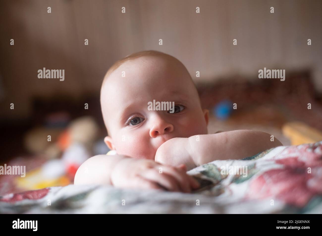 Portrait of a caucasian little baby girl looking pensive and sad. Stock Photo