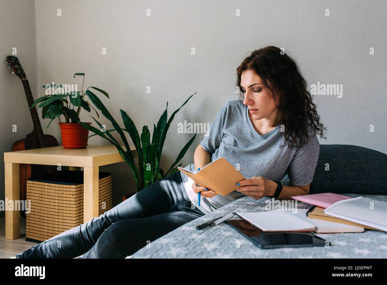 Woman working from home studying. Advanced training, retraining profession. Stock Photo