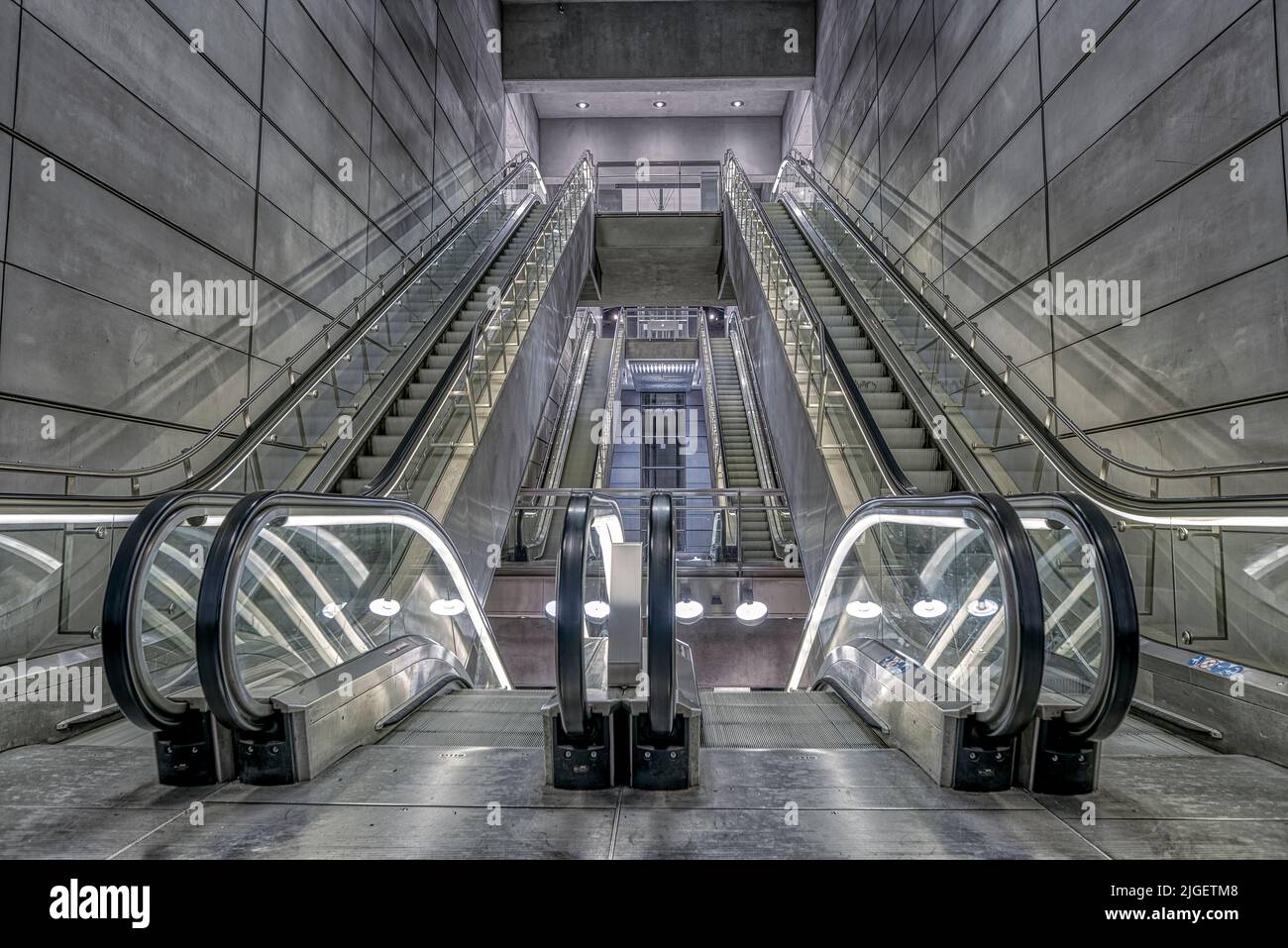 escalators in a grey futuristic light at Amagerbro Metro Station in Copenhagen Stock Photo
