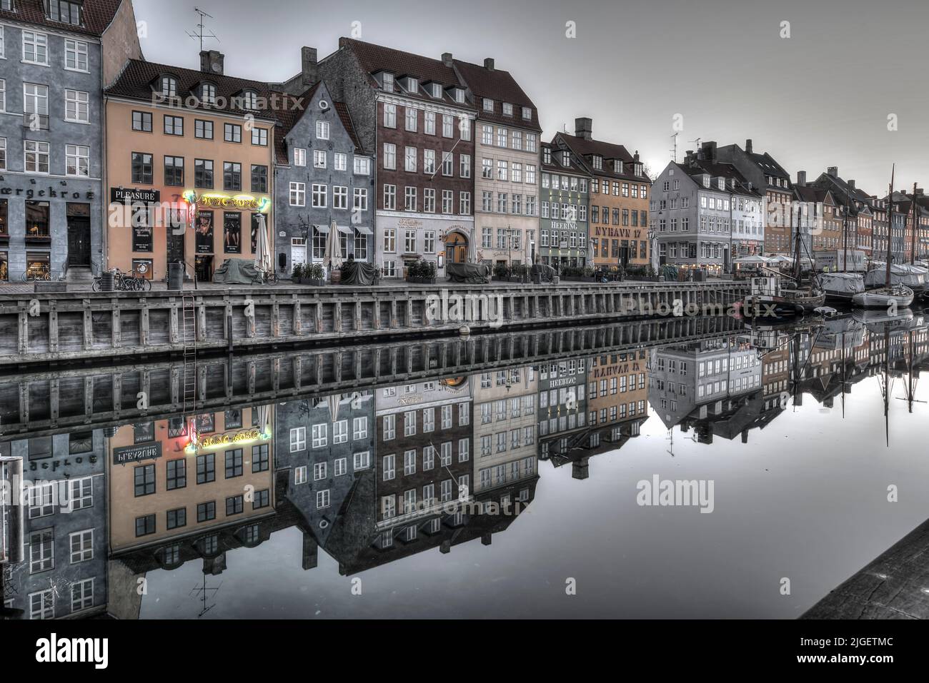 Nyhavn an early grey winter morning with reflections in the canal, Copenhagen, February 16, 2019 Stock Photo