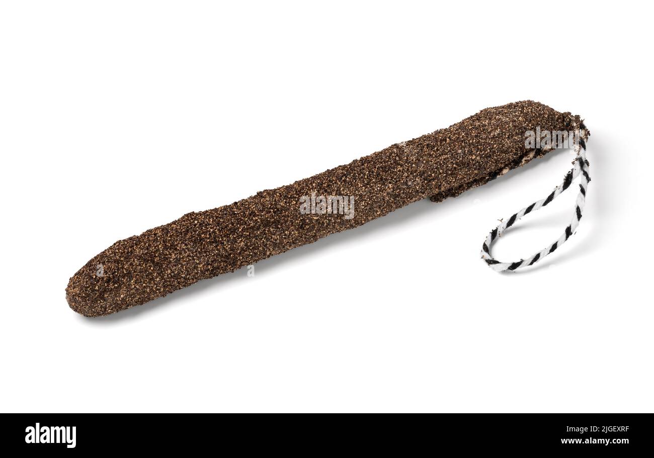Traditional Catalan sausage, fuet,  covered with black pepper on white background close up Stock Photo