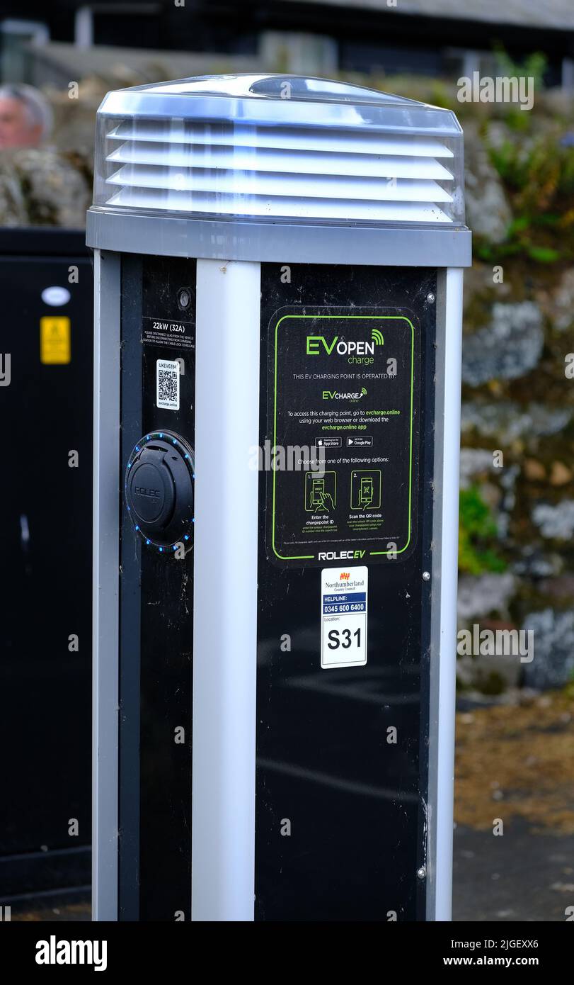 Modern electric car charging point in car park for public use. Stock Photo