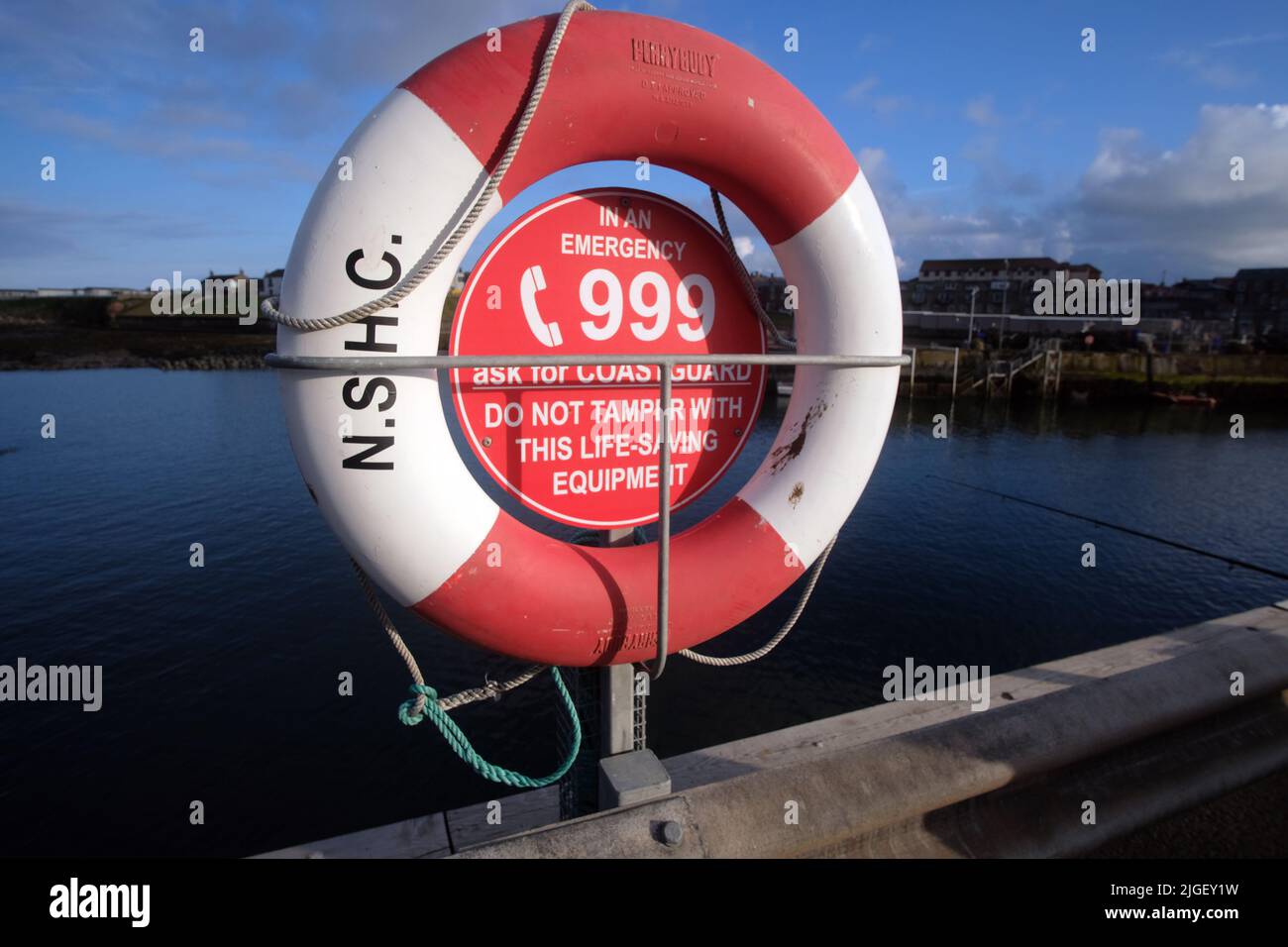 Safety ring with rope on harbour jetty for public use Stock Photo Alamy