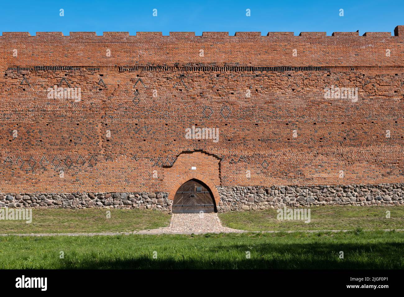 Castle of the Masovian Dukes defensive brick wall and entry gate in Ciechanow, Poland, medieval fortress dating back to the 14th century. Stock Photo