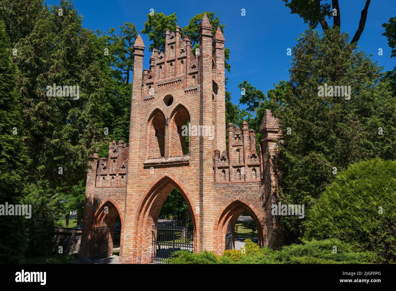 The Belfry Gate in Ciechanow, Poland. Neo-Gothic (Gothic Revival) style architecture with three ogival arcades with pinnacles, city landmark from the Stock Photo