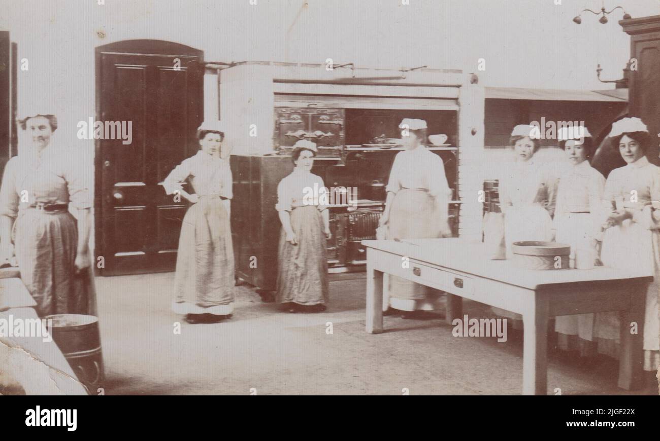 Edwardian cook and domestic servants in the kitchen of a large house, early 20th century Stock Photo