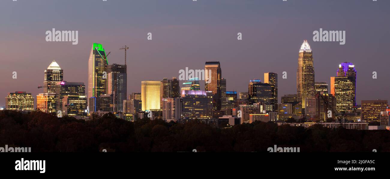 A panoramic view of the Charlotte, North Carolina, skyline at dusk with skyscraper lighted in multi-colors. Stock Photo