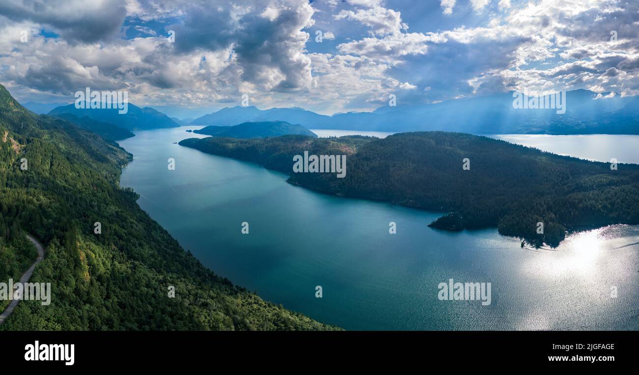 Panoramic format photo of a dramatic sunset sky over the Harrison Lake ...