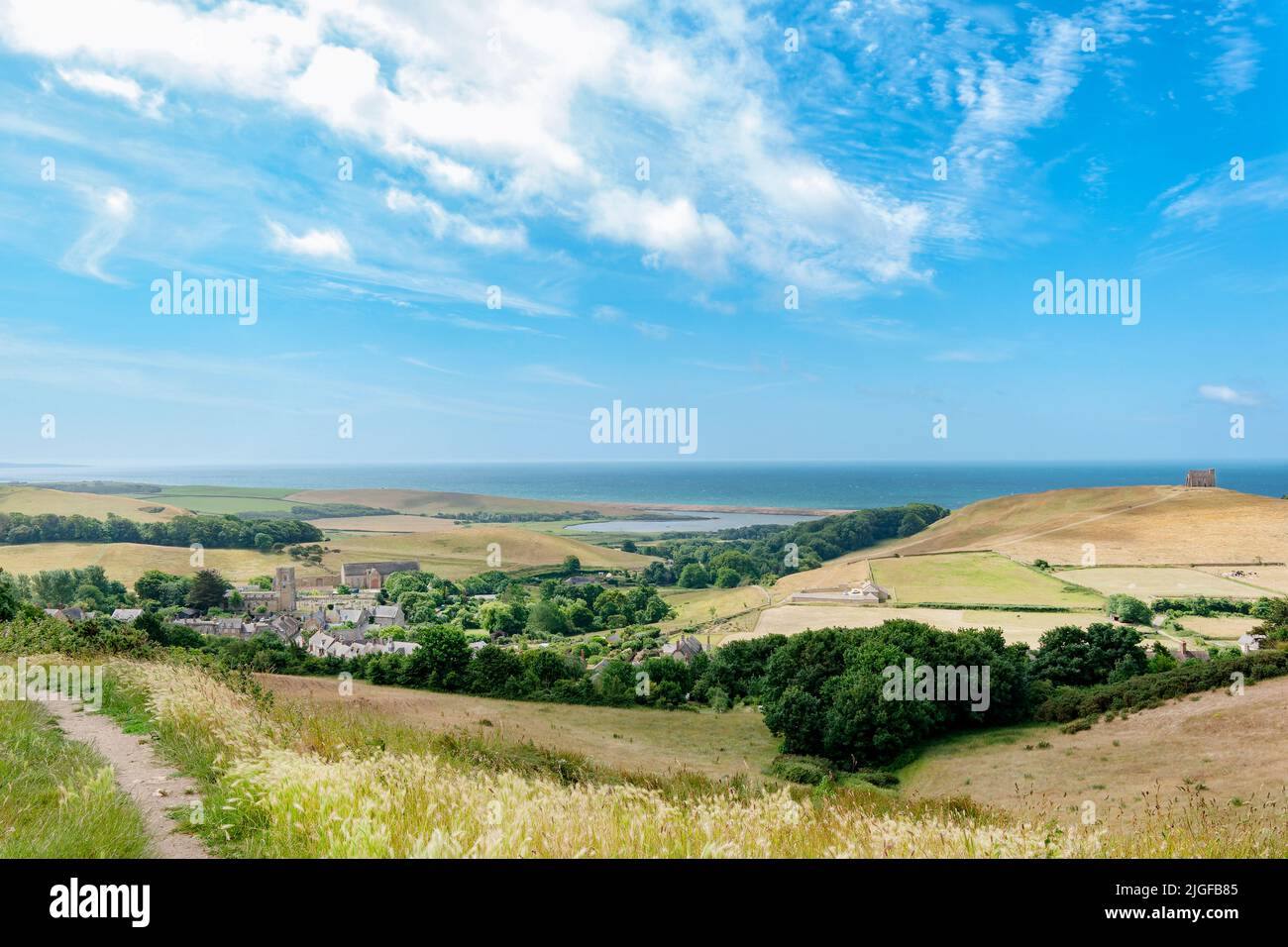 Abbotsbury, Dorset. A landscape hilltop view across countryside to the Jurassic coastline and English channel including the village of Abbotsbury Stock Photo